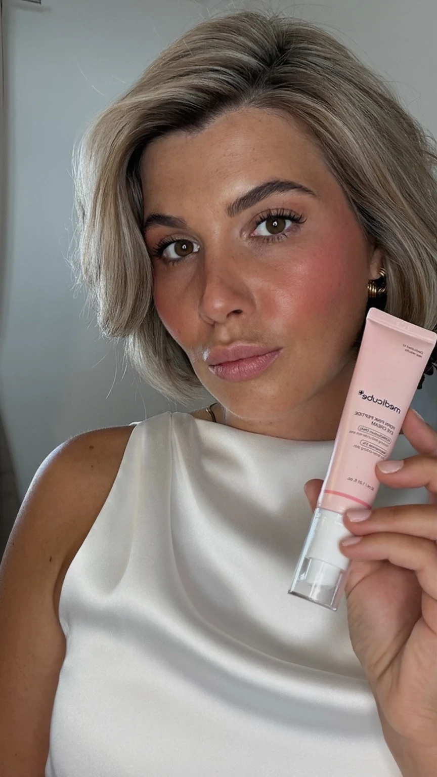 Lara holding a skincare product