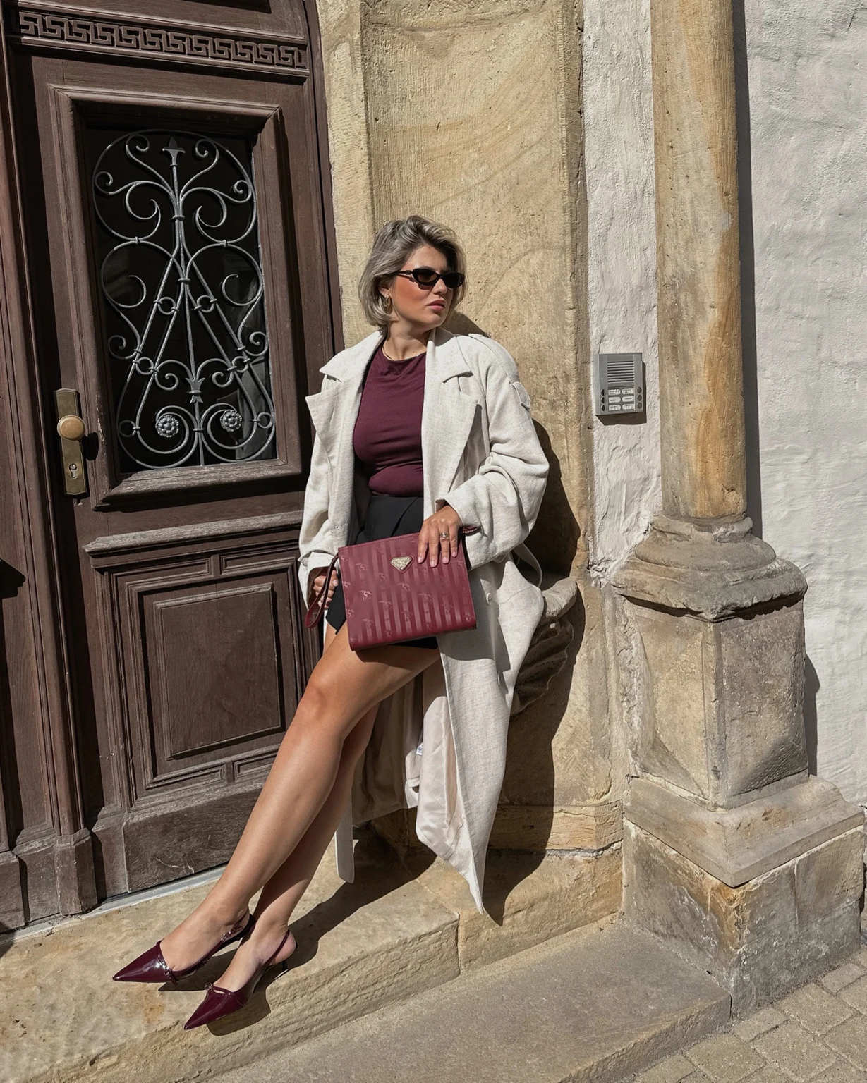 Lara Lehrmann in a light blazer outside a historic building