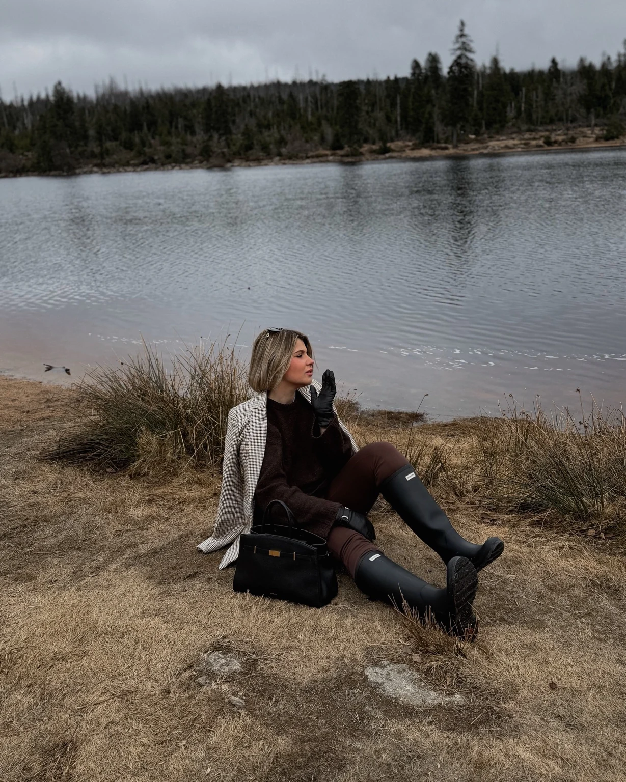 Lara sitting beside a lake