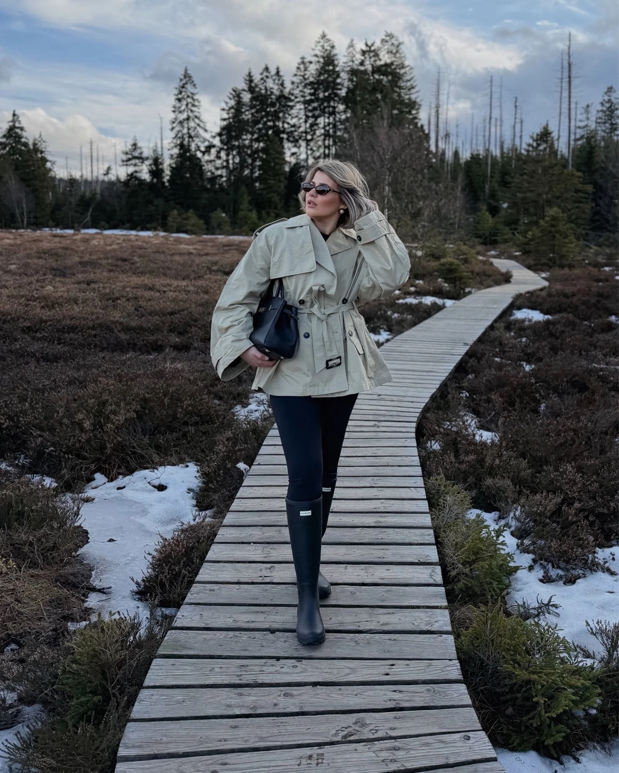 Lara on a wooden path through the countryside